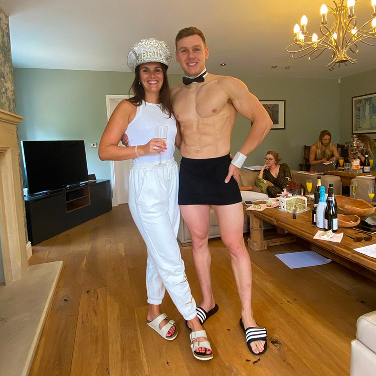 Butlers in the buff posing with a guest