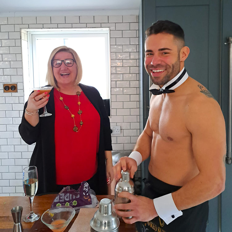 Butlers in the Buff Scotland serving cocktails to guests at a hen party in a Glasgow City Center Airbnb.