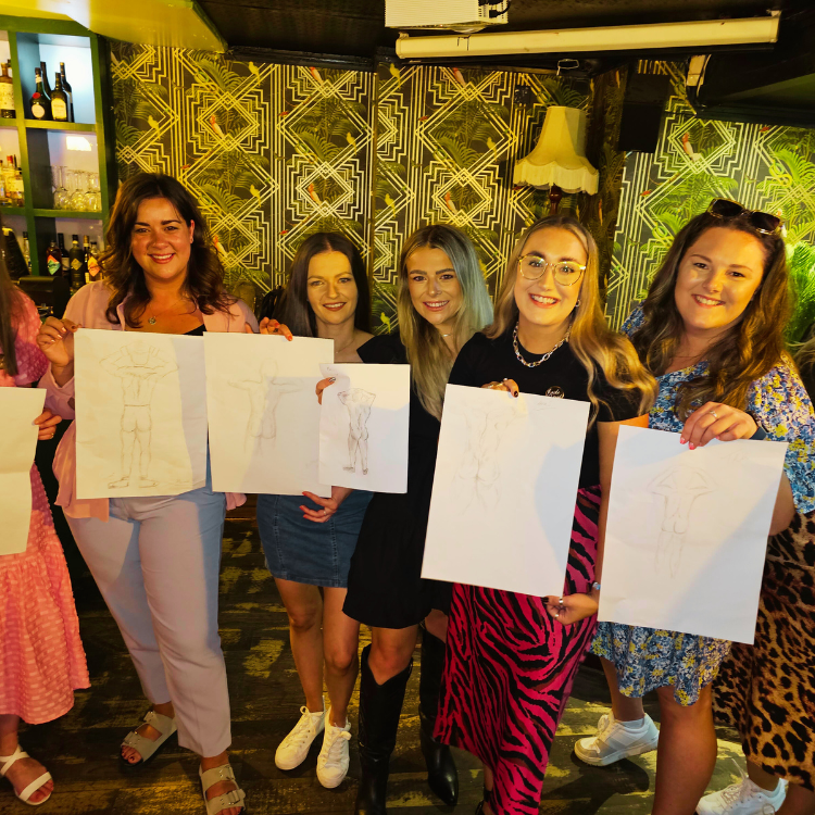 Guests proudly showcasing their artwork at a Hen Party Life Drawing in Hersham. Hersham Hen Party Life Drawing