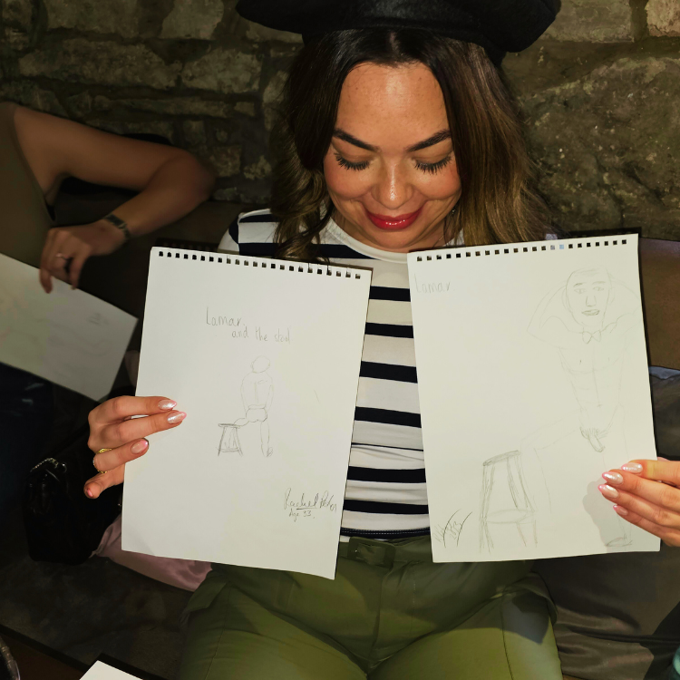 A guest comparing her drawing to others' at a Hen Party Life Drawing Class