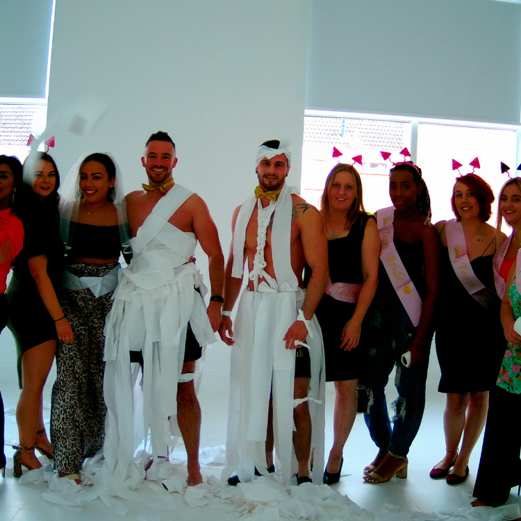 Buff butlers in Camden entertaining guests by dressing up as a bride-to-be with toilet rolls at a hen party