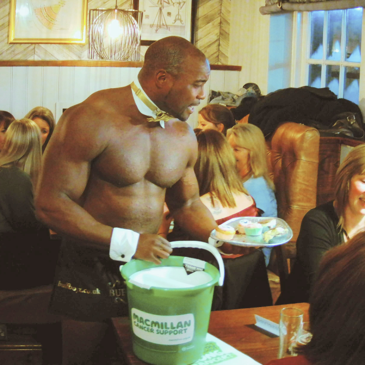 Naked butlers in Barnet with a Macmillan Cancer Research charity box, collecting donations at a charity event in Barnet