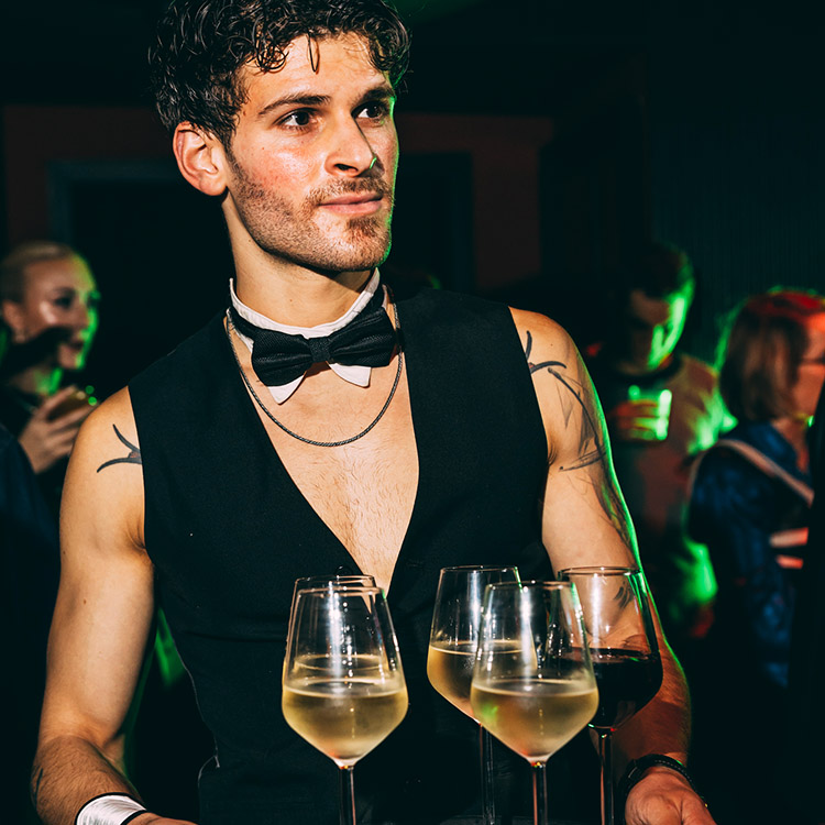 naked butlers in Thetford diligently offering drinks to attendees at a grand 50th birthday bash